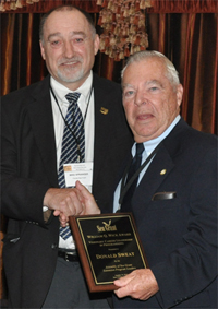 Mike Spranger presents Don Sweat (right) with the Wick Award.
