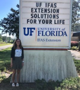 Kovacs in front of UF/IFAS Extension sign