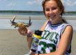Sophie Maginnes holding a crab on the beach.