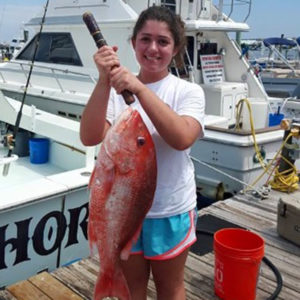 Amy Fellgren, 2021 Aylesworth Scholar, holding fish