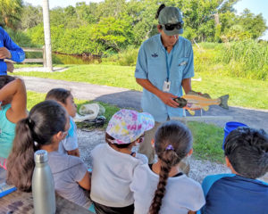 environmental educator teaching kids about fish biology