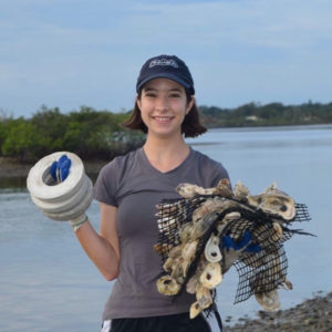 Katherine Harris, 2021 Aylesworth Scholar, holding research equipment