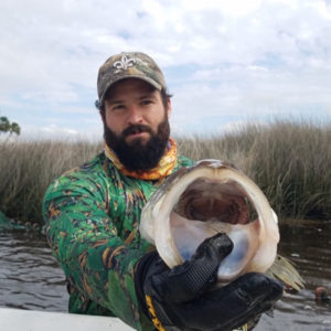 Scott Alford, 2021 Aylesworth Scholar, holding fish